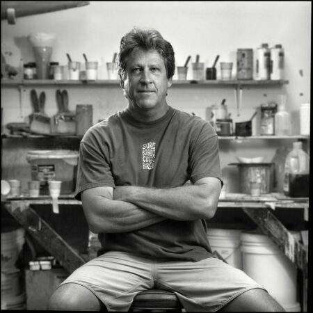 portrait of Chris Birch at the R&D surfboard manufacturing factory inside the pin lining room